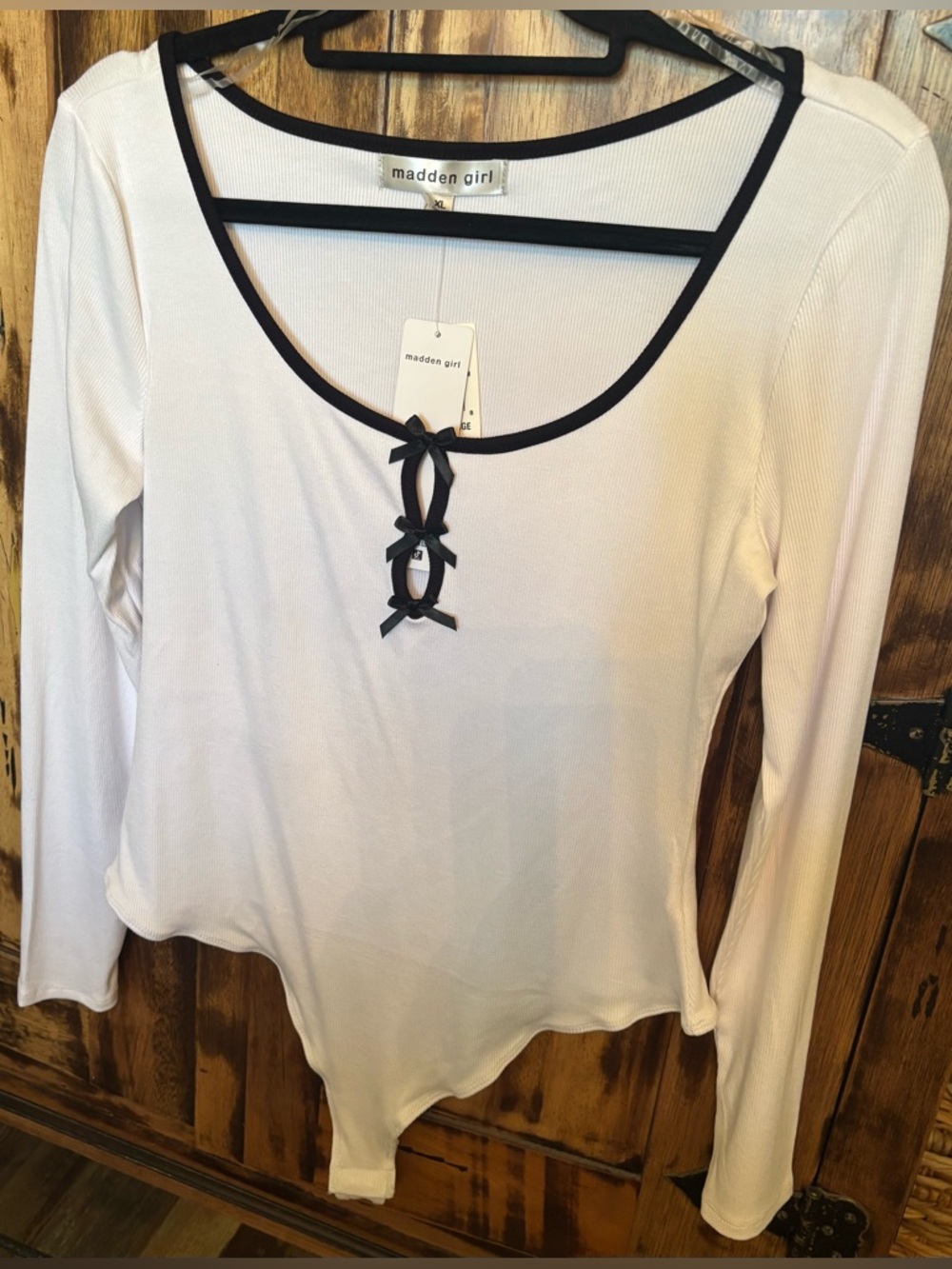 Madden Girl white long-sleeve bodysuit with black trim and bows